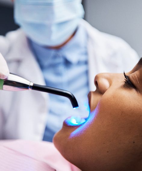 Profile view of woman having filling hardened with UV light