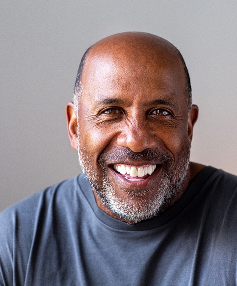 Closeup of senior man in gray shirt smiling