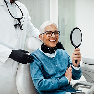 Senior woman smiling while looking at reflection