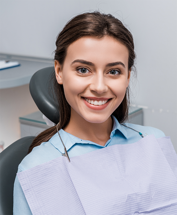 Brunette woman smiling in the dental chair