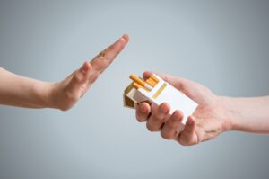 Person turning down offer of cigarette.